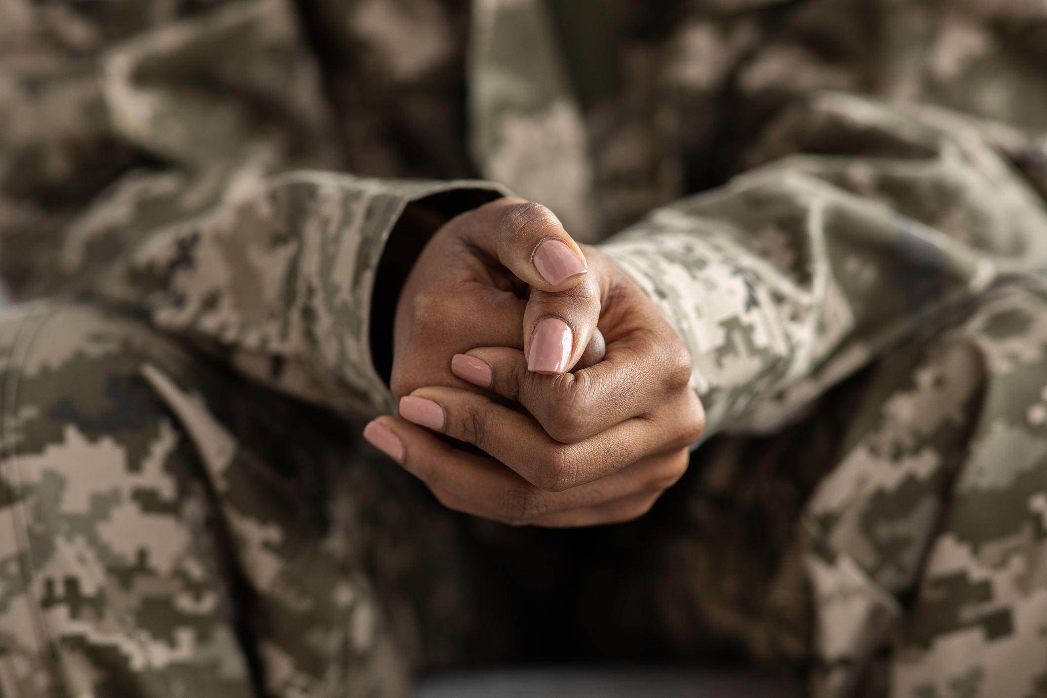 Military member clutches her hands