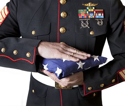 US marine holding american flag