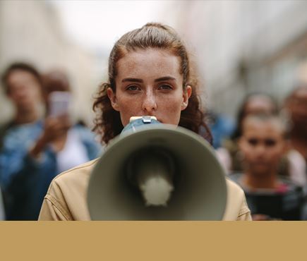 women with loud speaker at a rally