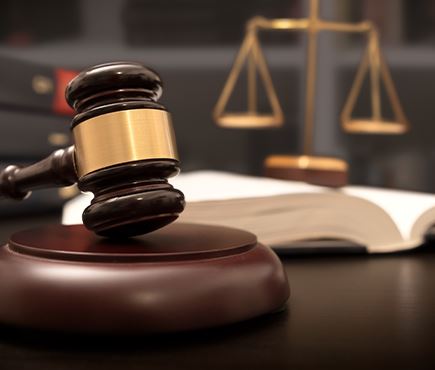 Gavel and book open on desk